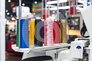 Many colorful cotton reel thread set up at modern and automatic high technology sewing or embroidery machine for textile Ã¢â¬â